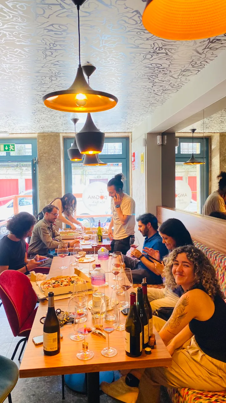 The dining room full of guests under warm pendant light